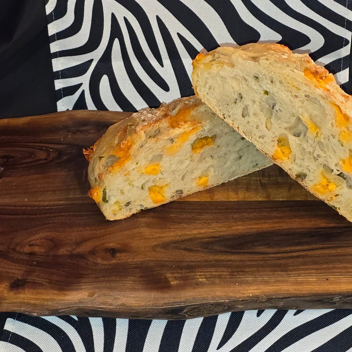Cross-section of a cheddar jalapeño sourdough loaf showing the cheesy crumb