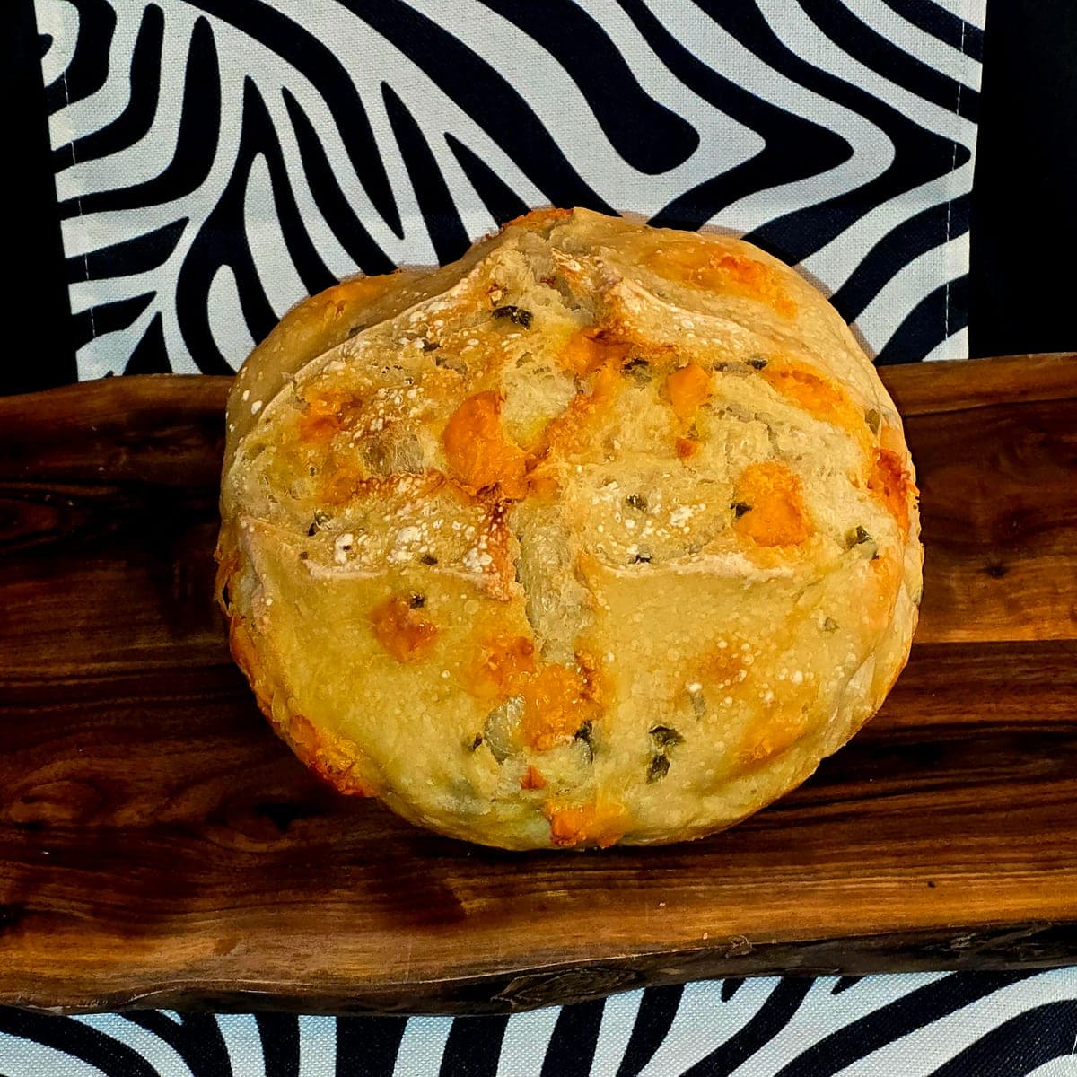 Cheddar Jalapeño sourdough loaf with melted cheese crust