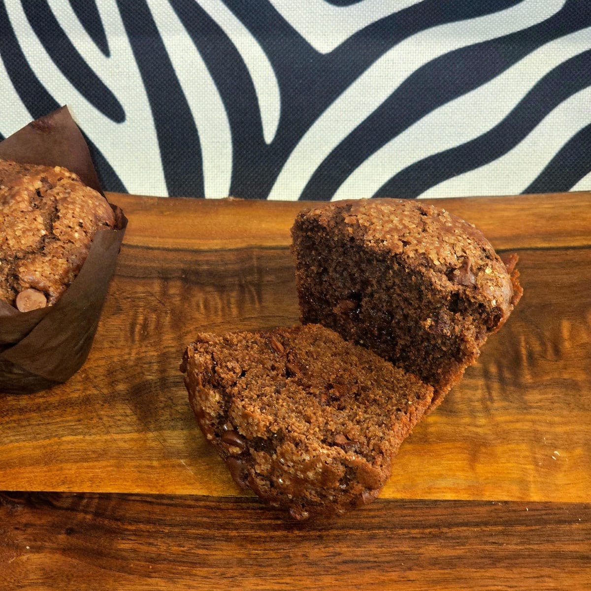 Halved double chocolate muffin showing melted chocolate chips inside